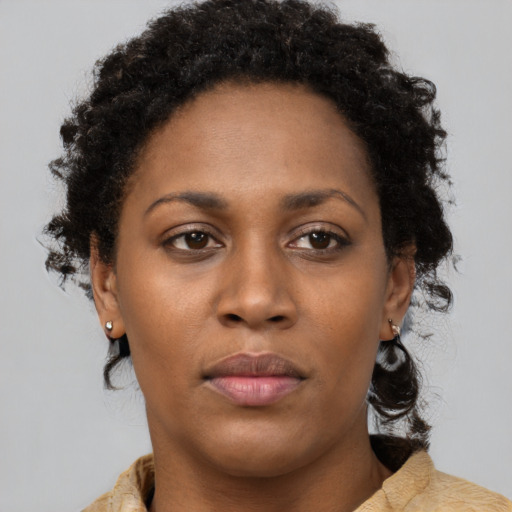 Neutral black young-adult female with medium  brown hair and brown eyes