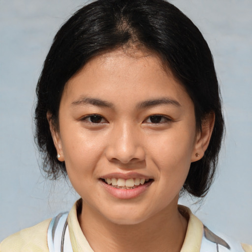 Joyful asian young-adult female with medium  brown hair and brown eyes