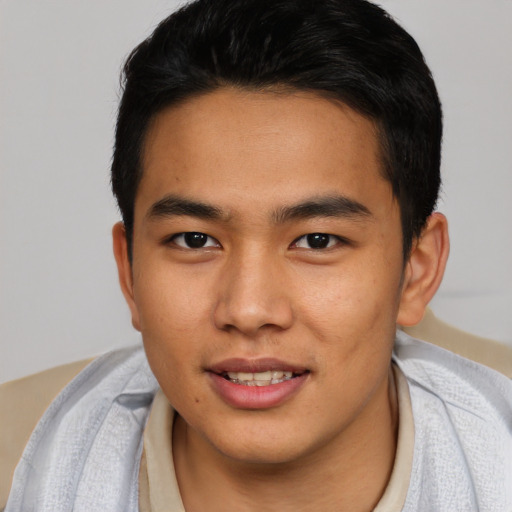 Joyful asian young-adult male with short  black hair and brown eyes
