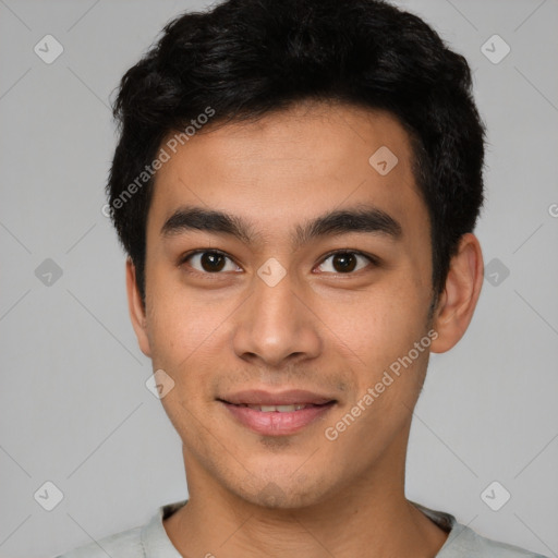 Joyful latino young-adult male with short  black hair and brown eyes