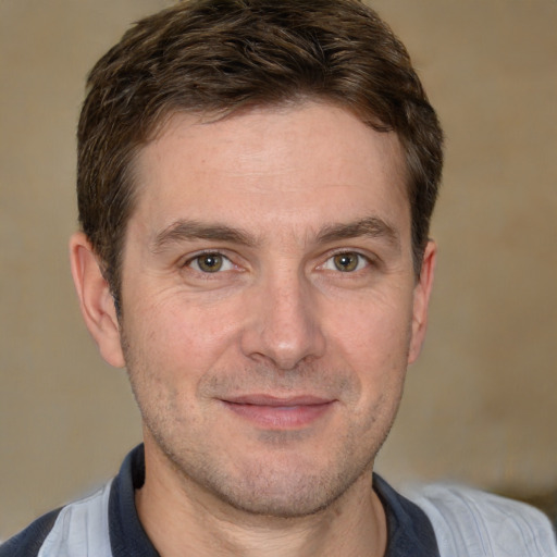 Joyful white adult male with short  brown hair and brown eyes