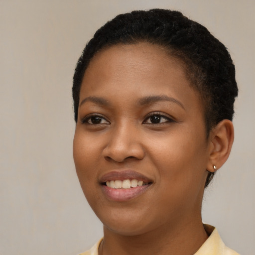 Joyful black young-adult female with short  brown hair and brown eyes