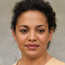 Joyful latino adult female with short  brown hair and brown eyes