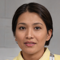 Joyful asian young-adult female with medium  brown hair and brown eyes