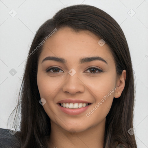 Joyful latino young-adult female with long  brown hair and brown eyes