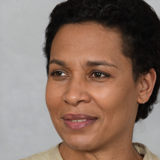 Joyful latino adult female with short  brown hair and brown eyes