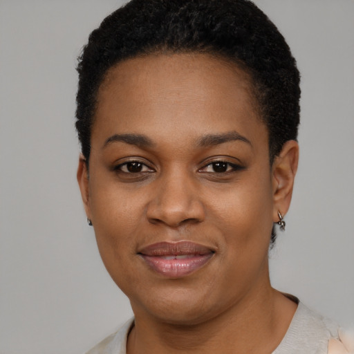 Joyful black young-adult female with short  black hair and brown eyes
