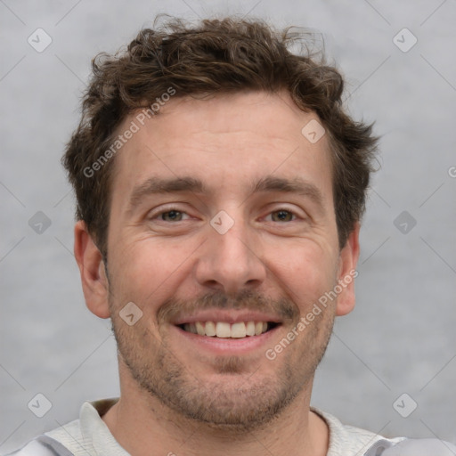 Joyful white adult male with short  brown hair and grey eyes