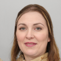 Joyful white adult female with long  brown hair and brown eyes