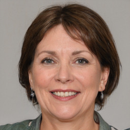 Joyful white adult female with medium  brown hair and grey eyes