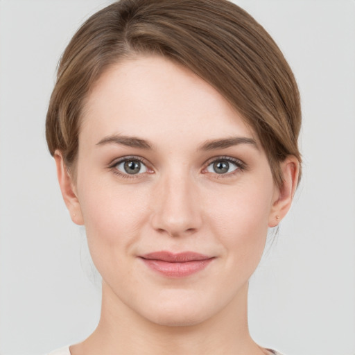 Joyful white young-adult female with short  brown hair and grey eyes