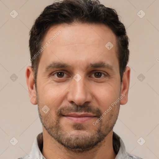 Joyful white adult male with short  brown hair and brown eyes