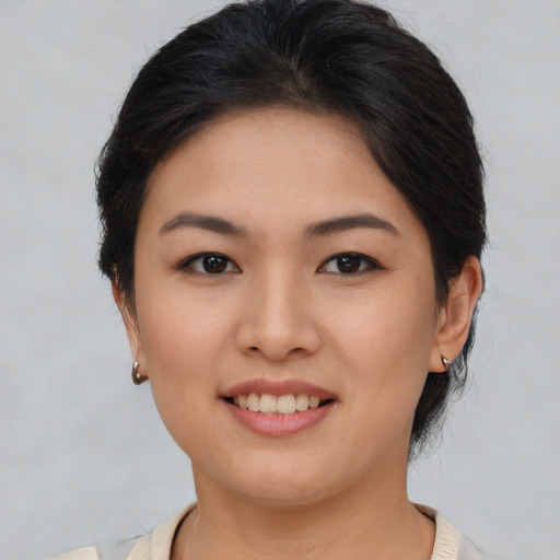 Joyful asian young-adult female with medium  brown hair and brown eyes