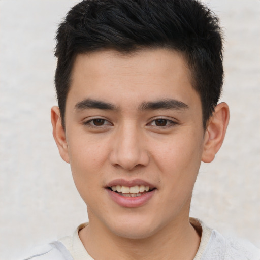 Joyful asian young-adult male with short  brown hair and brown eyes