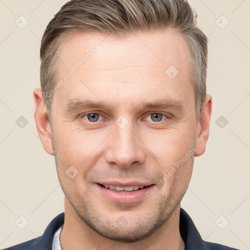 Joyful white adult male with short  brown hair and grey eyes