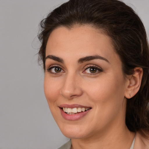 Joyful white young-adult female with medium  brown hair and brown eyes