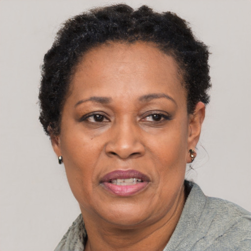 Joyful black adult female with short  brown hair and brown eyes