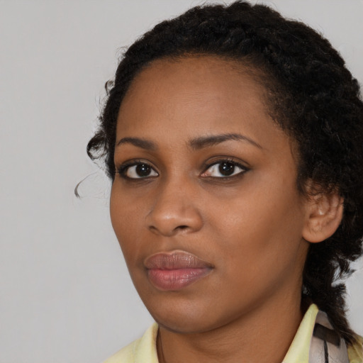 Neutral black young-adult female with medium  brown hair and brown eyes