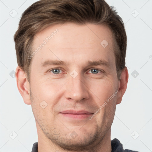 Joyful white adult male with short  brown hair and grey eyes