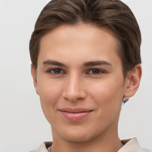 Joyful white young-adult female with short  brown hair and grey eyes