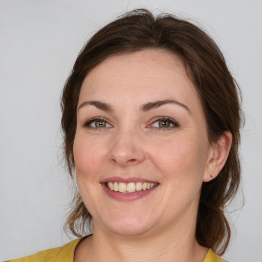 Joyful white young-adult female with medium  brown hair and brown eyes