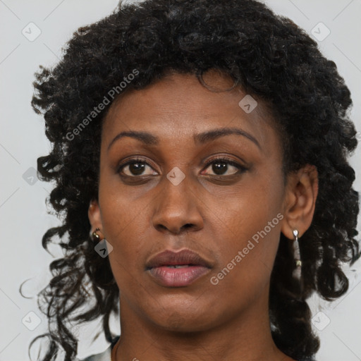 Joyful black adult female with short  brown hair and brown eyes