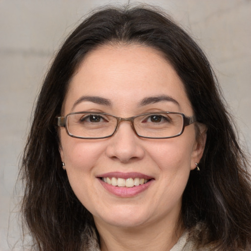 Joyful white adult female with long  brown hair and brown eyes