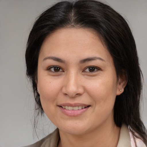 Joyful asian adult female with medium  brown hair and brown eyes