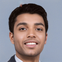 Joyful white young-adult male with short  black hair and brown eyes