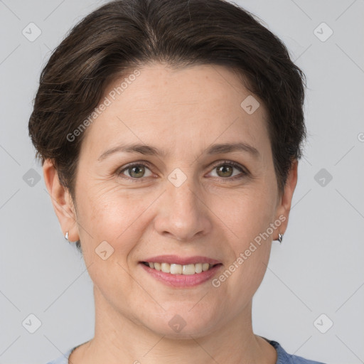 Joyful white adult female with short  brown hair and grey eyes