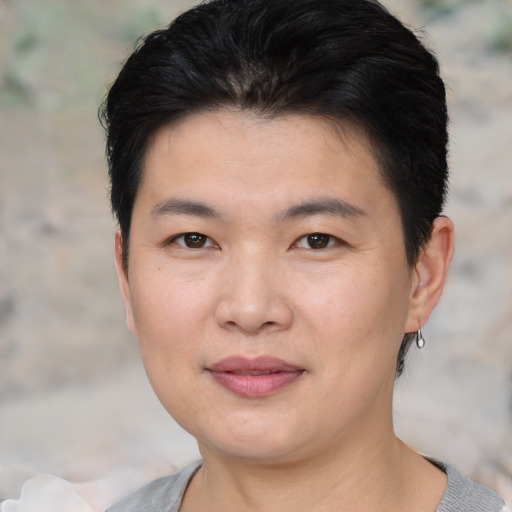 Joyful asian young-adult female with short  black hair and brown eyes