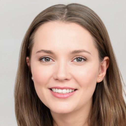 Joyful white young-adult female with long  brown hair and grey eyes