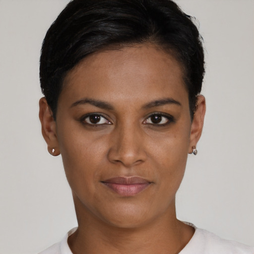 Joyful latino young-adult female with short  brown hair and brown eyes