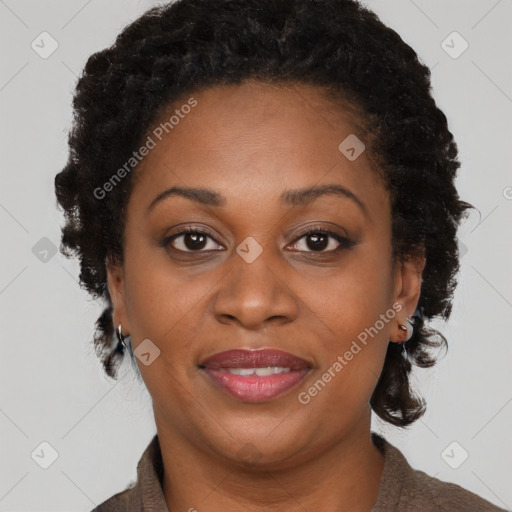 Joyful black adult female with short  brown hair and brown eyes