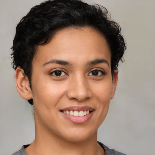 Joyful latino young-adult female with short  brown hair and brown eyes