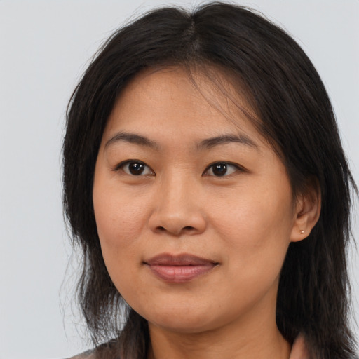 Joyful asian young-adult female with long  brown hair and brown eyes