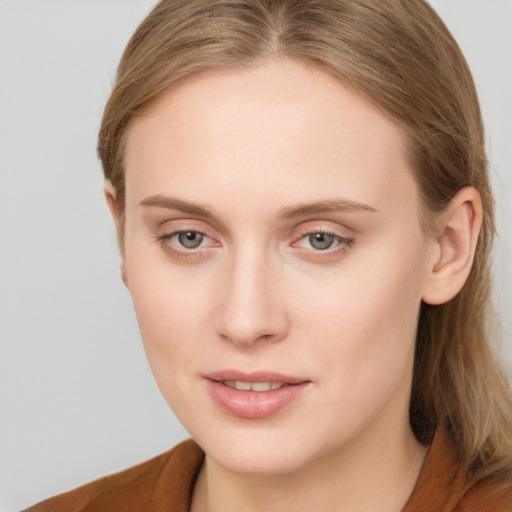 Joyful white young-adult female with long  brown hair and blue eyes