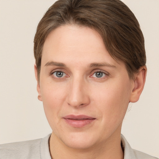 Joyful white young-adult female with short  brown hair and grey eyes