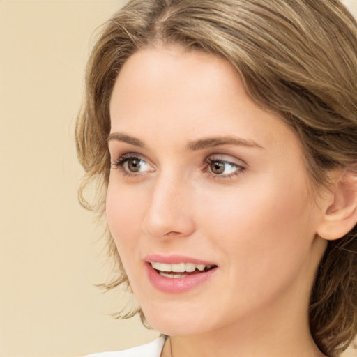 Joyful white young-adult female with medium  brown hair and green eyes