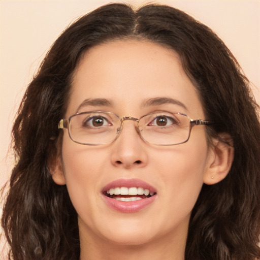 Joyful white adult female with long  brown hair and brown eyes