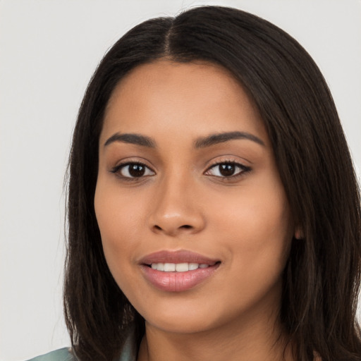 Joyful latino young-adult female with long  black hair and brown eyes