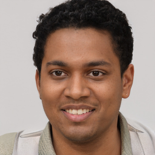 Joyful black young-adult male with short  black hair and brown eyes