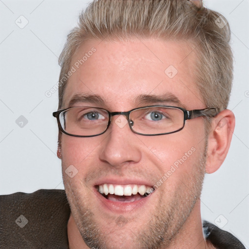 Joyful white adult male with short  brown hair and blue eyes