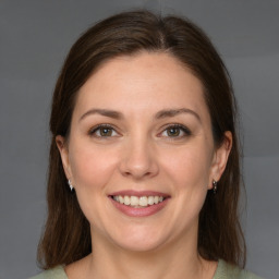 Joyful white young-adult female with medium  brown hair and grey eyes