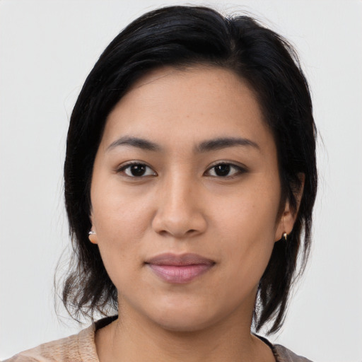 Joyful asian young-adult female with medium  black hair and brown eyes