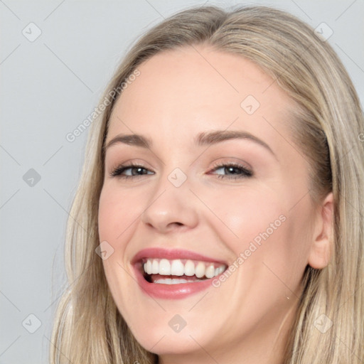 Joyful white young-adult female with long  brown hair and grey eyes