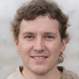 Joyful white adult male with short  brown hair and grey eyes