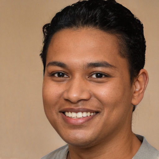 Joyful latino young-adult male with short  brown hair and brown eyes