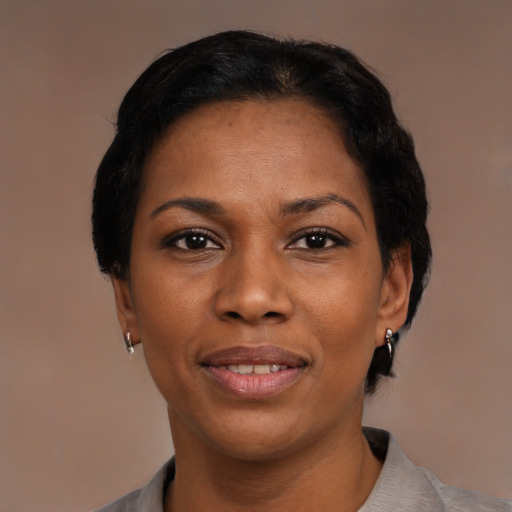 Joyful black adult female with short  black hair and brown eyes