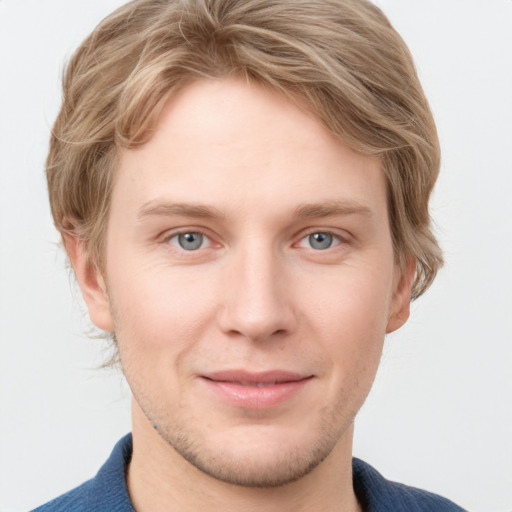 Joyful white young-adult male with short  brown hair and blue eyes